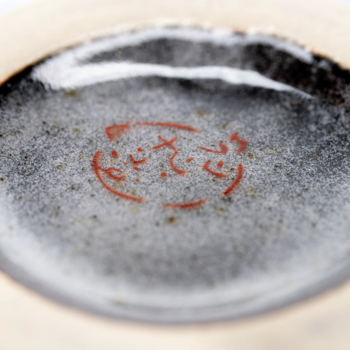Red maker's mark on the underside of the matcha bowl.
