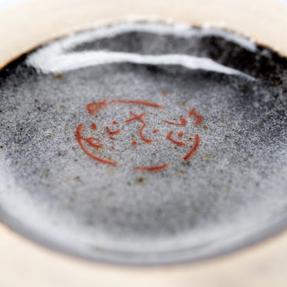 Red maker's mark on the underside of the matcha bowl.