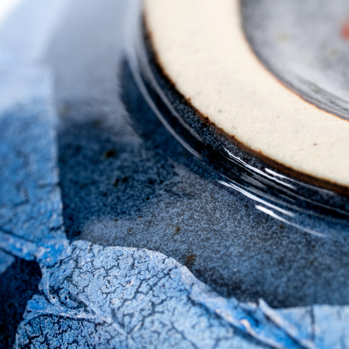 Close-up of the unglazed foot and blue silver-foil decoration.