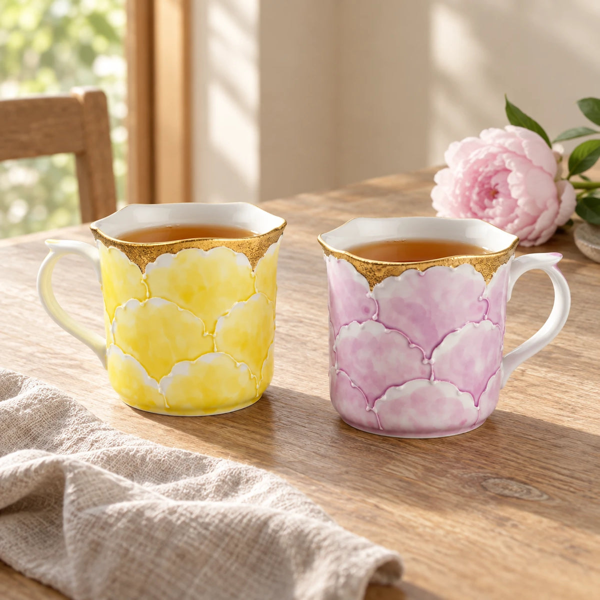 Yellow and purple Bunzan Peony Mug colour options, each holding tea on a sunlit wooden table.