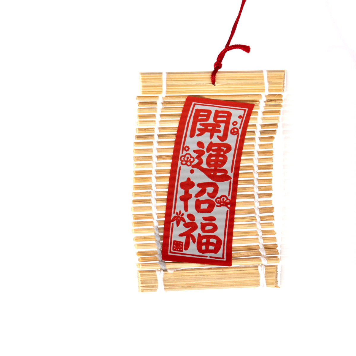 Red and white Japanese lettering on the wind chime's paper strip.