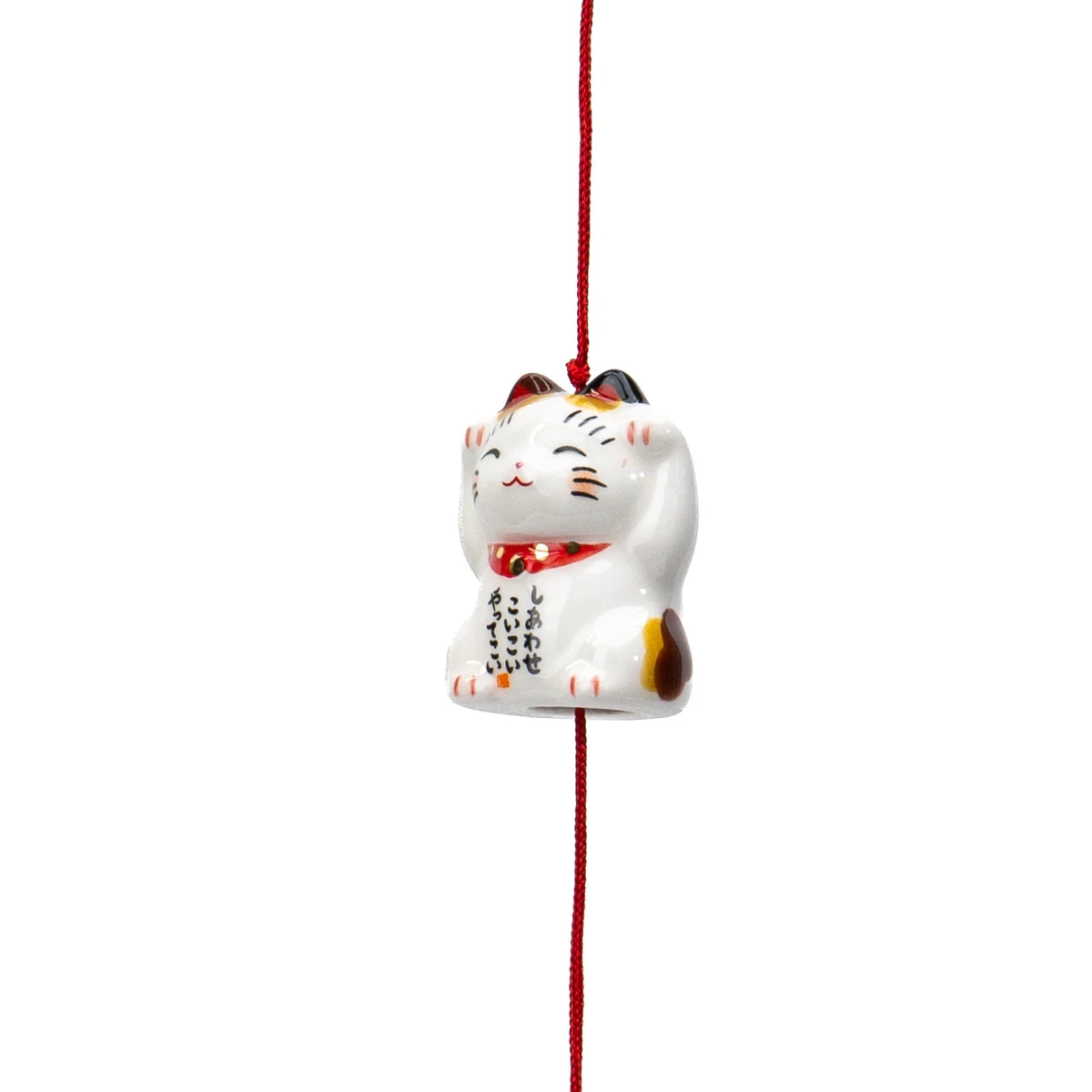 Close-up of the hanging calico cat wind chime and its red cord.
