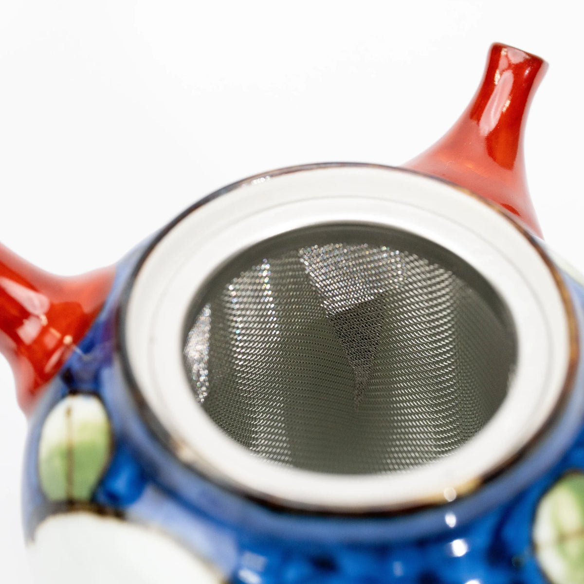View into the open blue camellia teapot, showing the removable metal mesh basket fitted inside.
