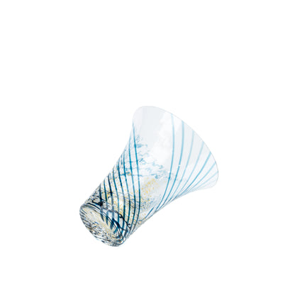 Yachiyo glass sake cup resting on its side, showing the flared shape.
