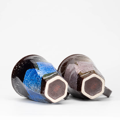 Undersides of the two mugs showing their polygonal feet.
