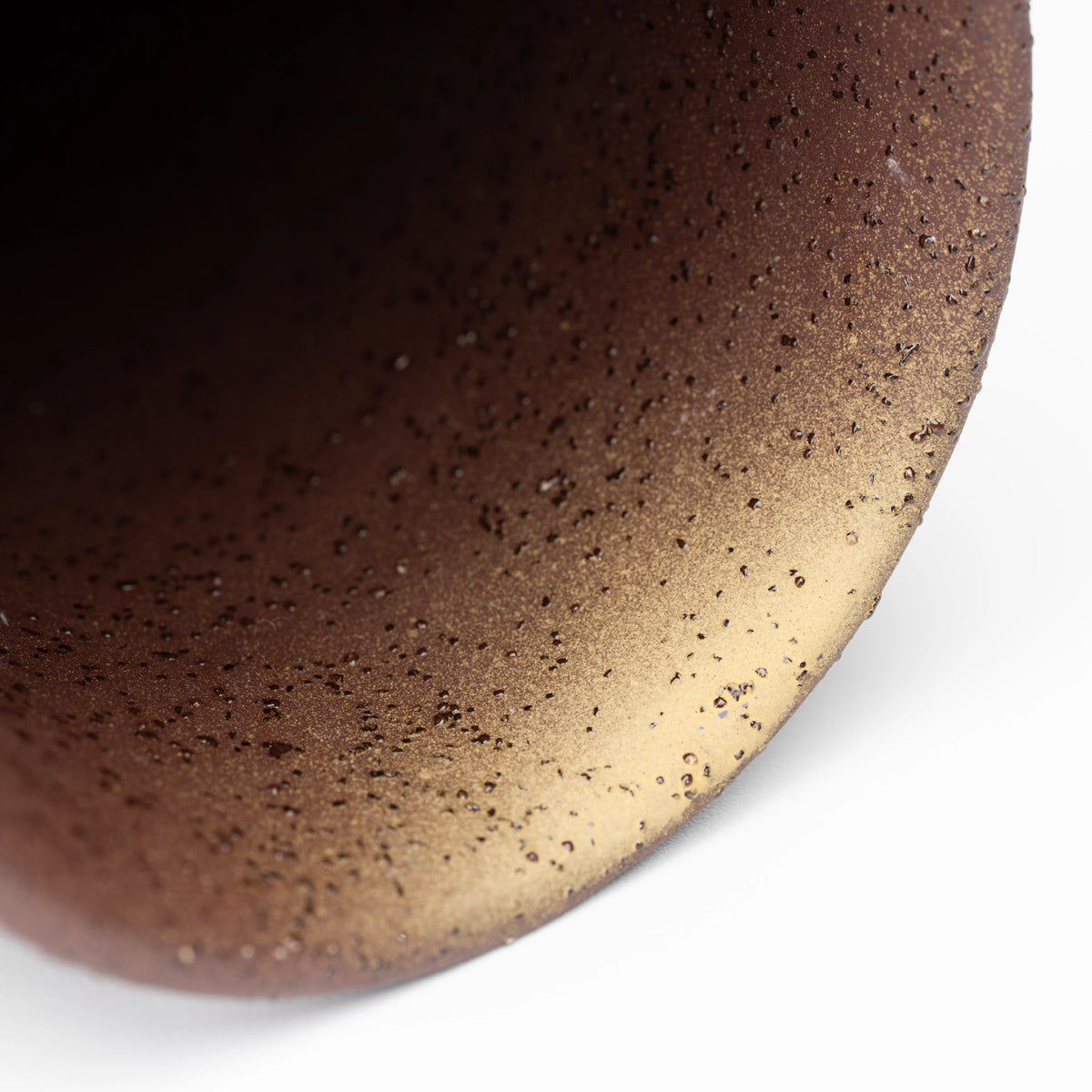 Close-up inside a warm brown speckled mug.