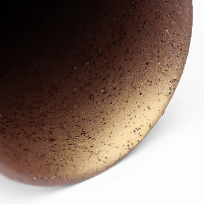 Close-up inside a warm brown speckled mug.