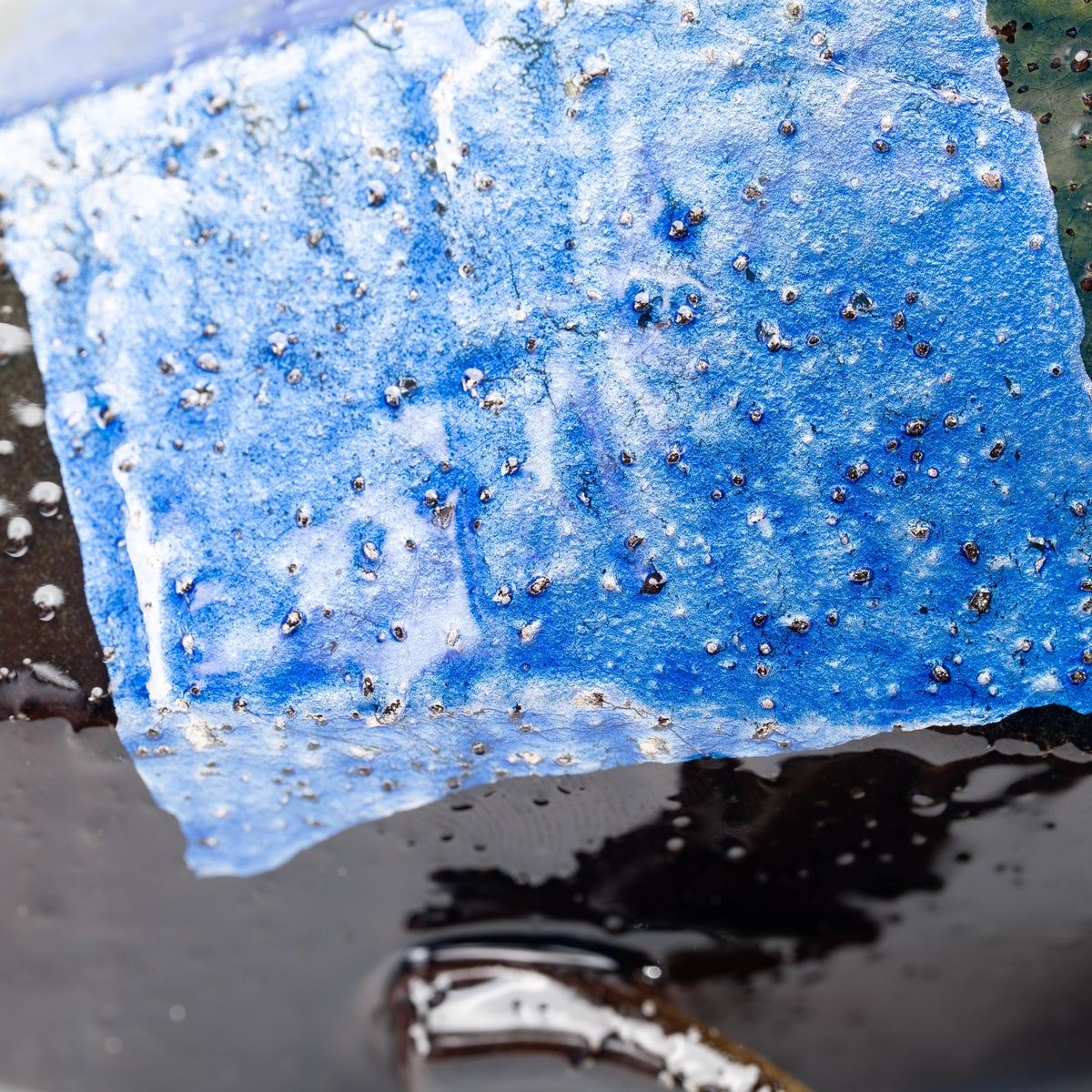 Bright blue silver-foil panel with fine surface texture.