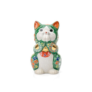 Green Kutani praying cat with joined paws and colorful floral decoration on white.