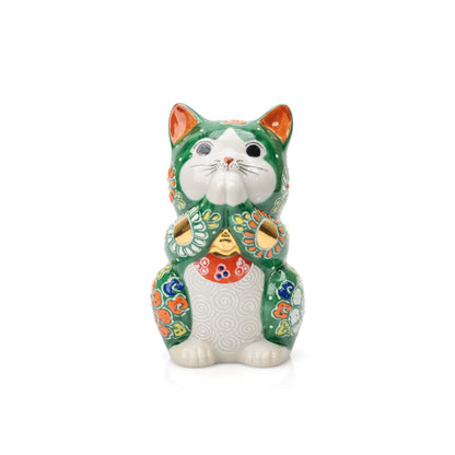 Green Kutani praying cat with joined paws and colorful floral decoration on white.