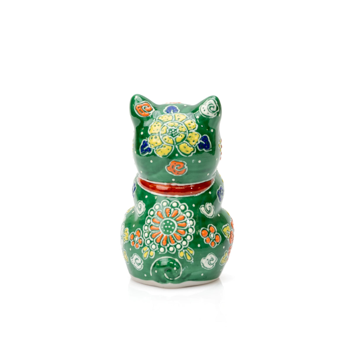 Back of the green praying cat with raised floral patterns and a red collar.