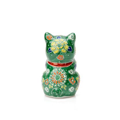 Back of the green praying cat with raised floral patterns and a red collar.