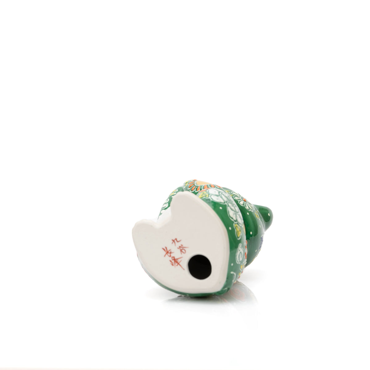 Underside of the green cat with a red inscription and round opening.