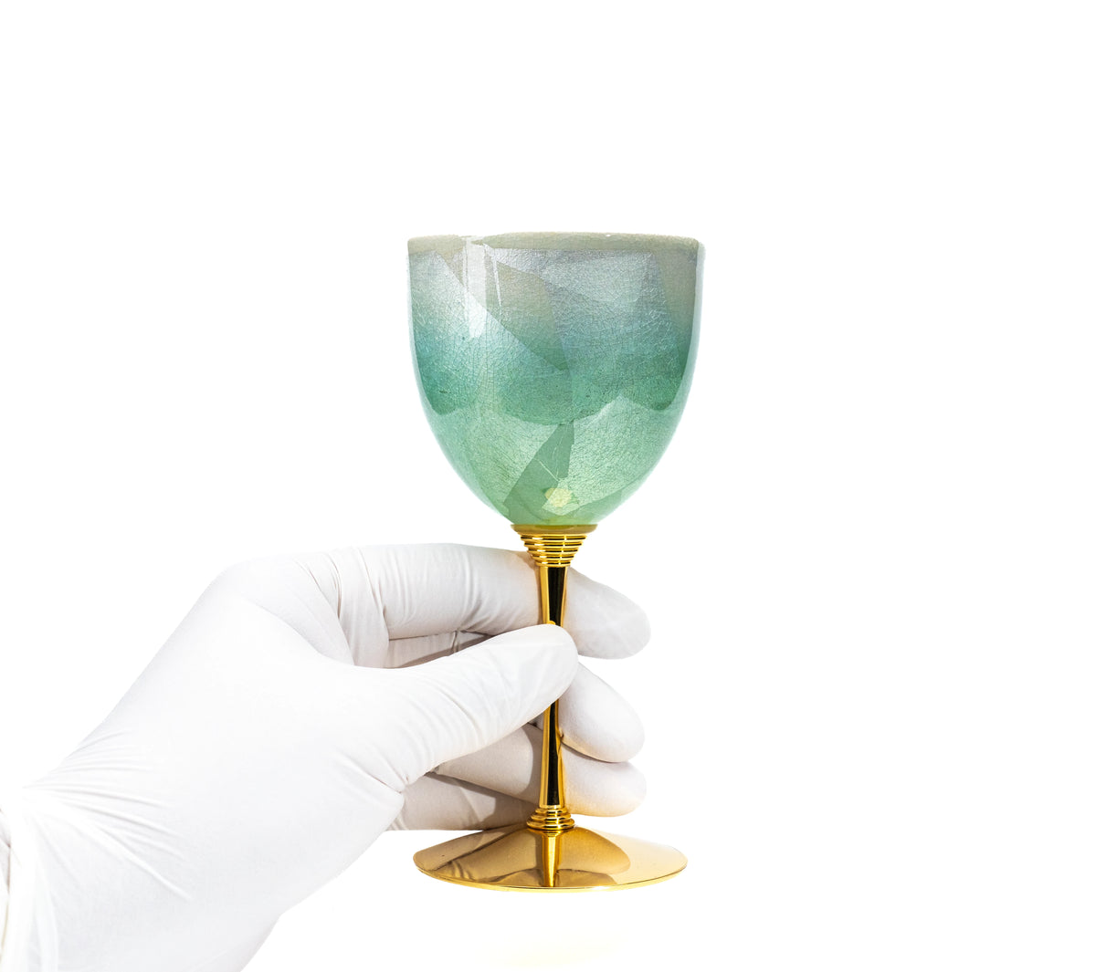 Green Kutani wine cup held in a gloved hand to show scale.