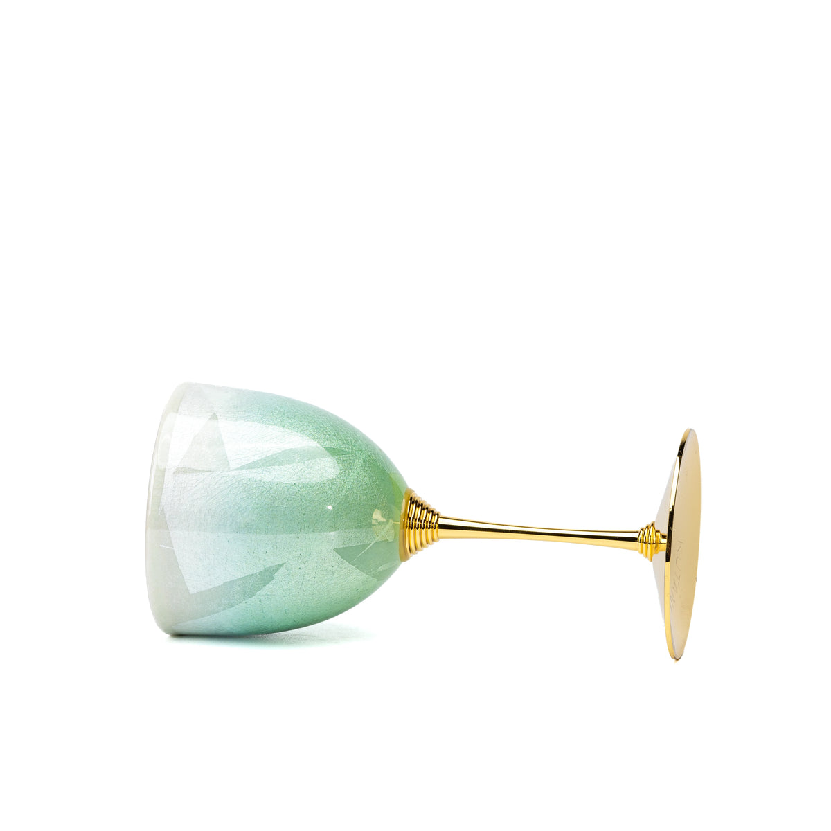 Side view of the green Kutani wine cup lying on a white background.