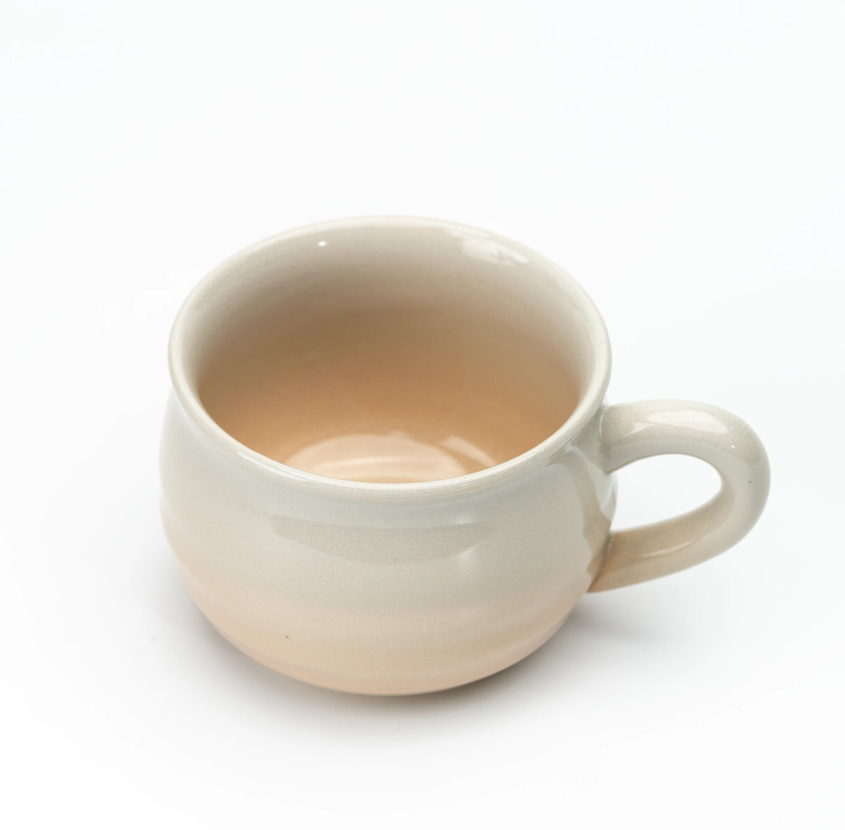 Overhead angled view of a Hagi cup and its beige interior.