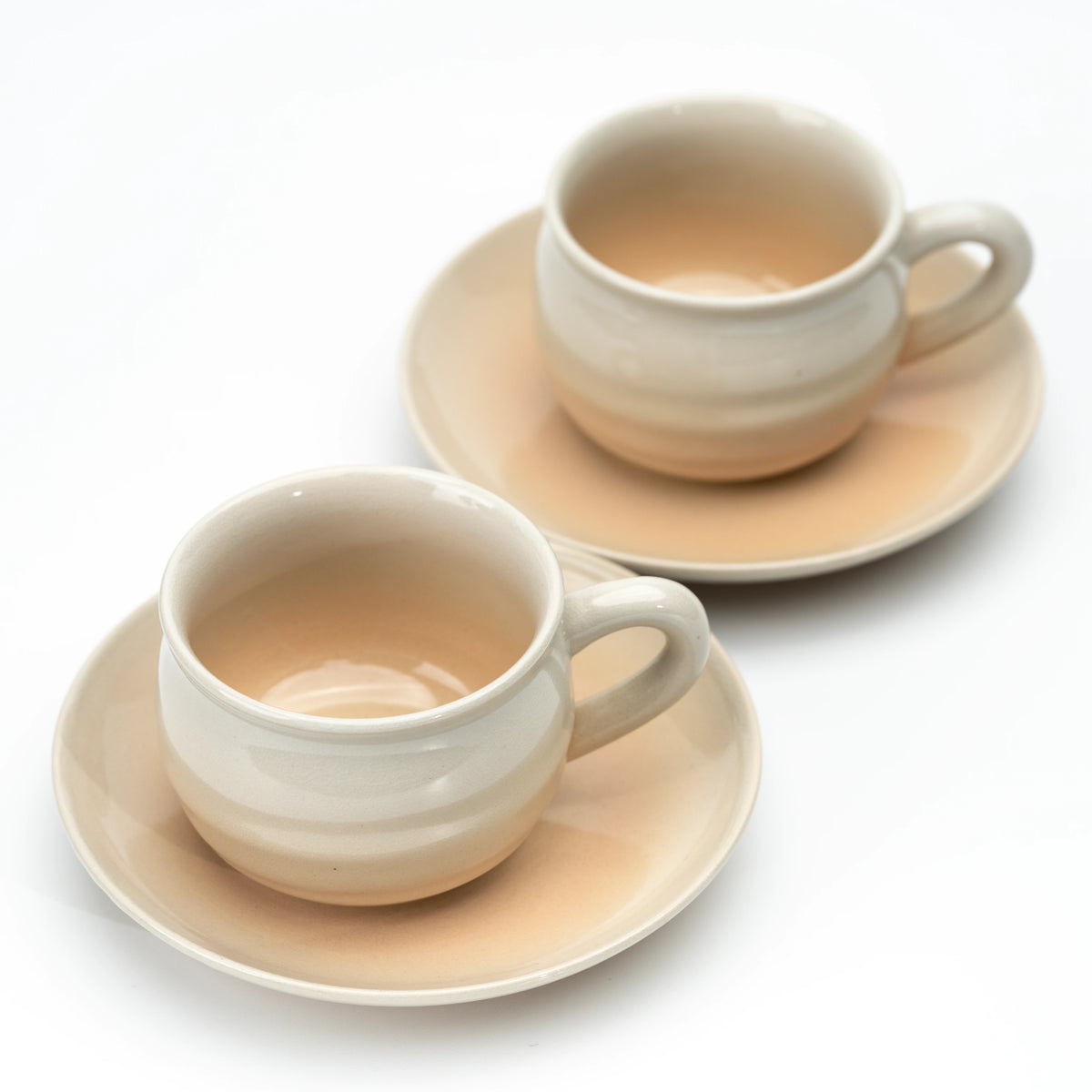 Two Hagi cups and saucers viewed from above on white.