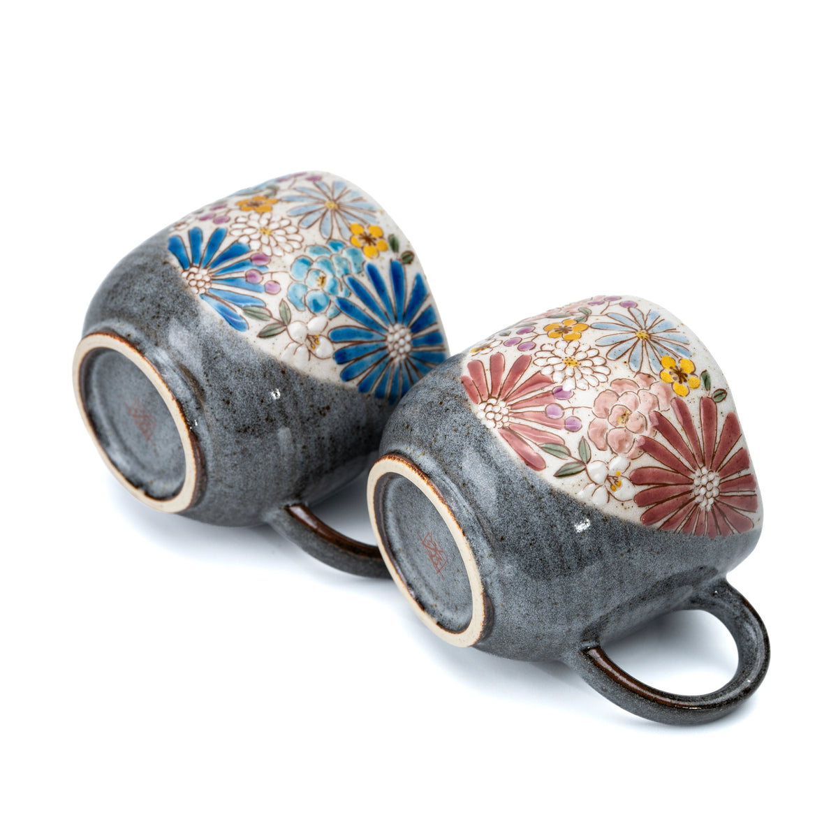 Undersides of the red and blue floral Kutani mugs showing their foot rings.
