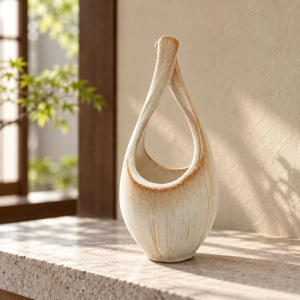 Hechimon Kairo tall cream ceramic vase standing empty on a pale stone ledge in soft morning light.