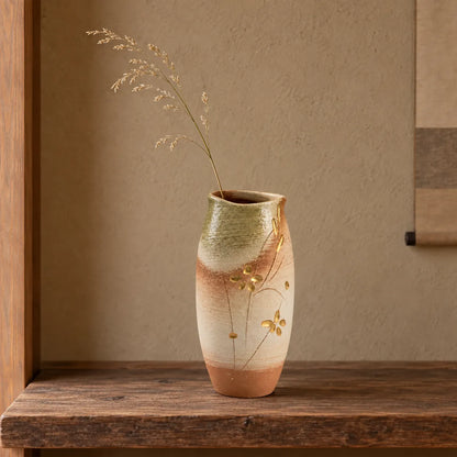 Hechimon Meiyo tall vase holding one light dried grass stem on an aged cedar shelf.