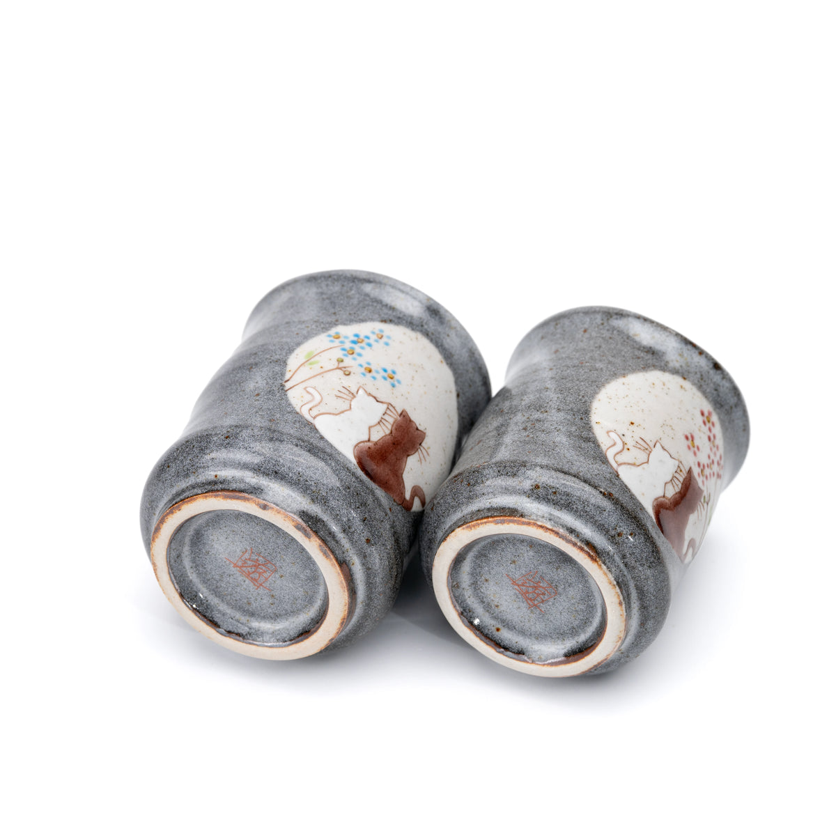 Undersides of the two gray Kutani cat yunomi cups.