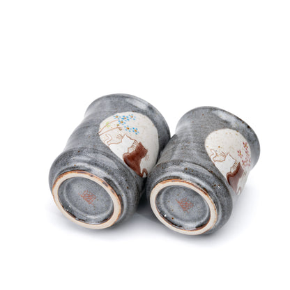 Undersides of the two gray Kutani cat yunomi cups.