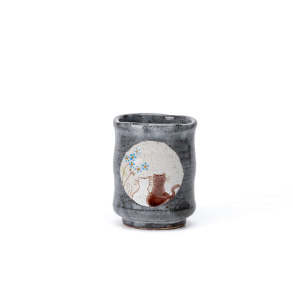 Front view of the larger Kutani cat yunomi with blue flowers.