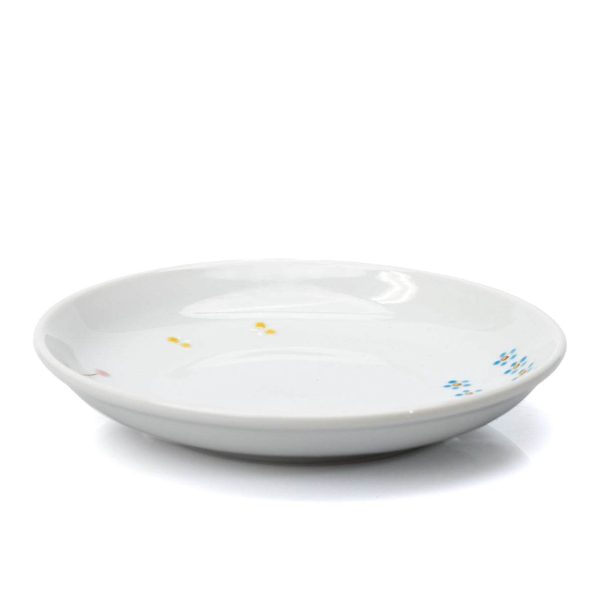 Low side view of the white cat plate and its shallow rim.