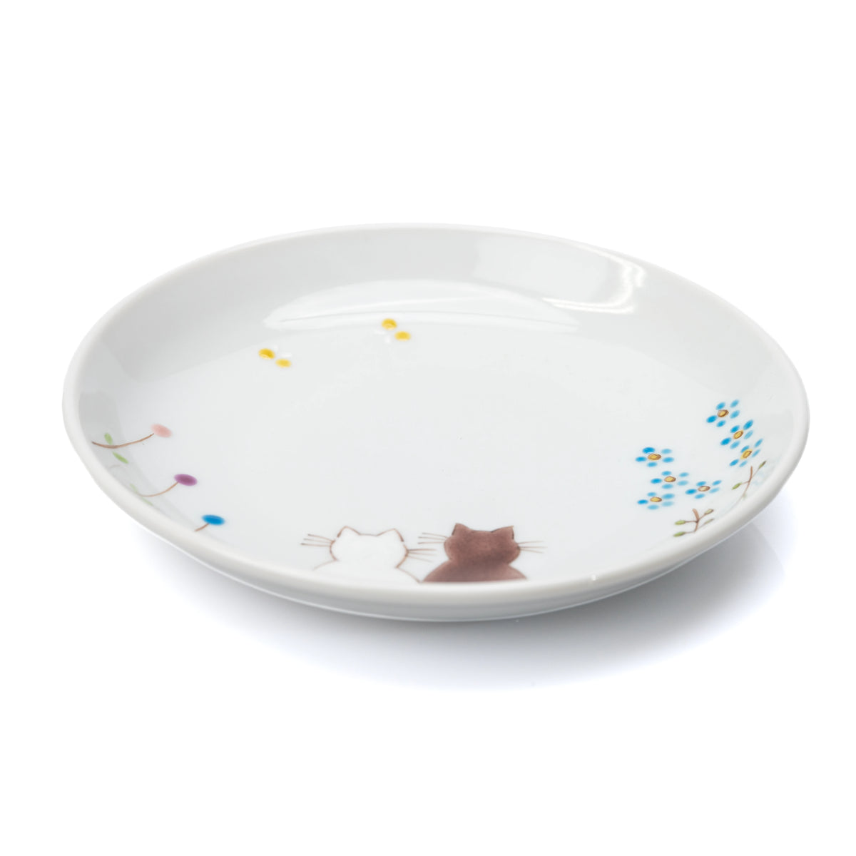 White Kutani plate with two seated cats, small flowers and butterflies on white.