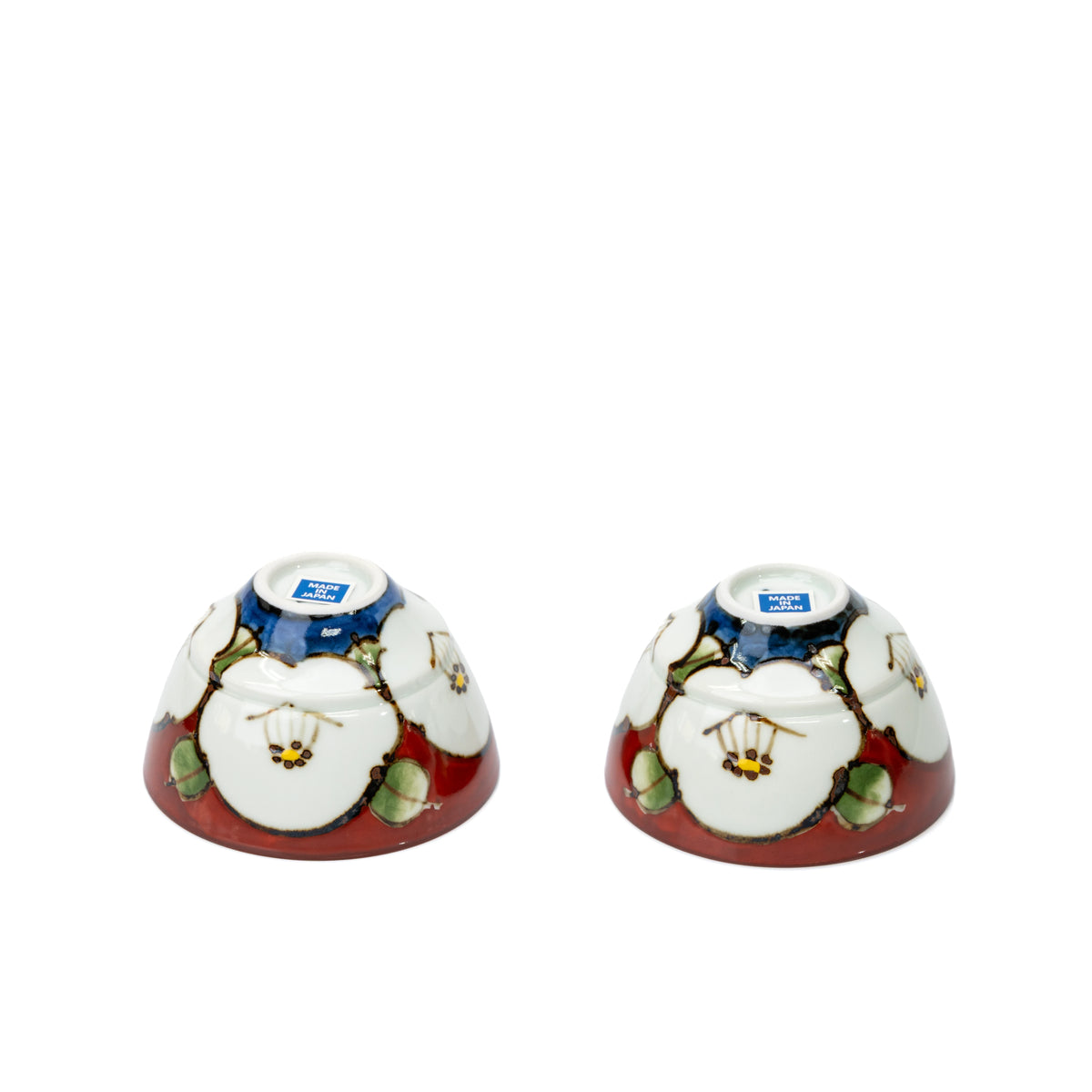 Undersides of the two red camellia teacups.