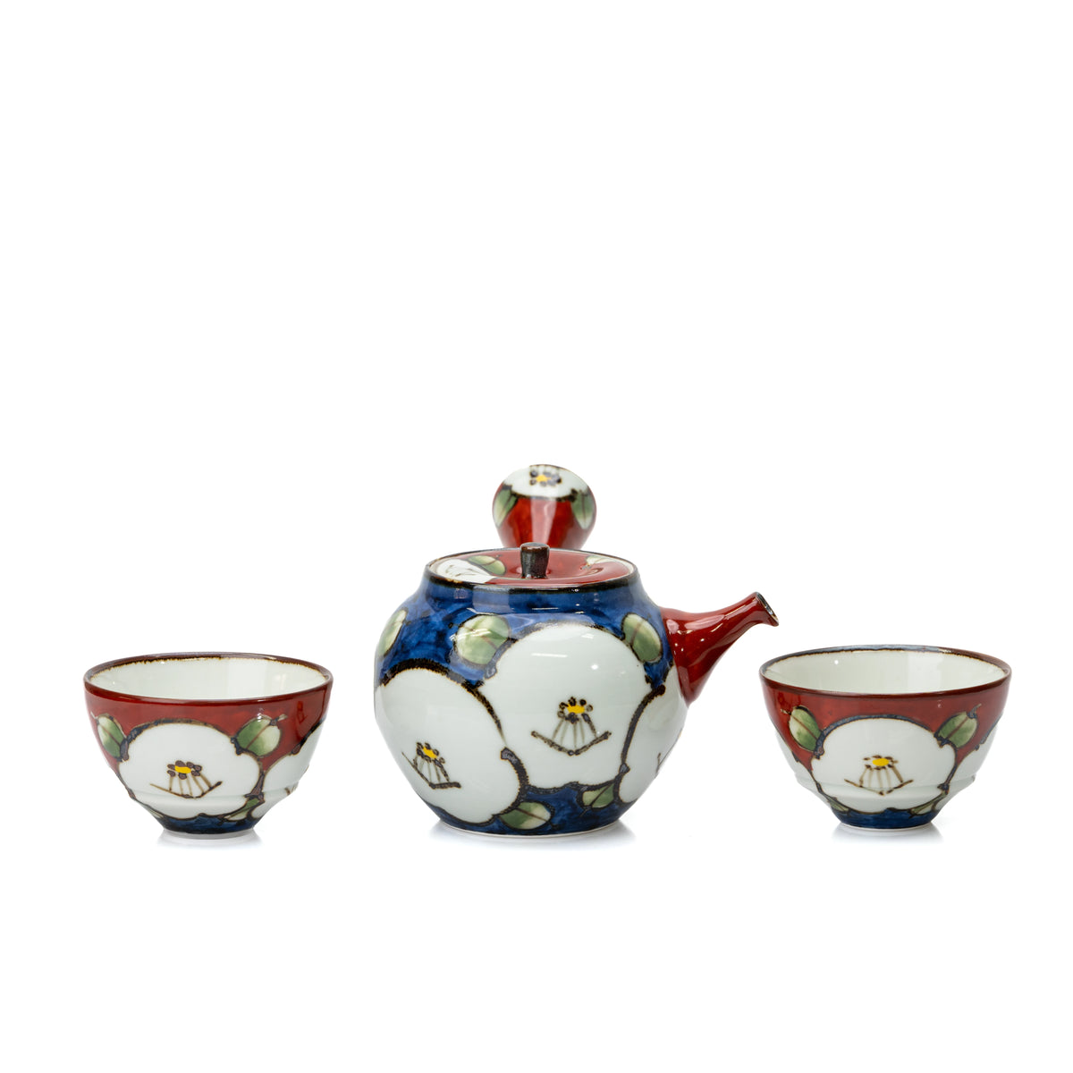 Camellia teapot between the two matching red teacups.