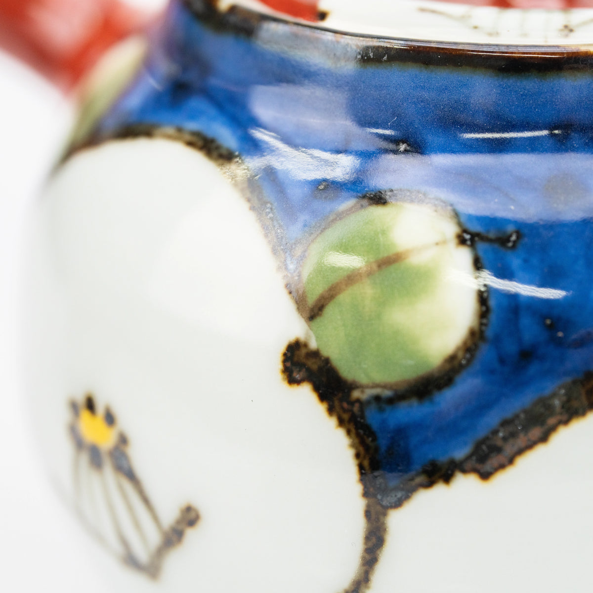 Green leaf, white flower and blue glaze on the teapot.