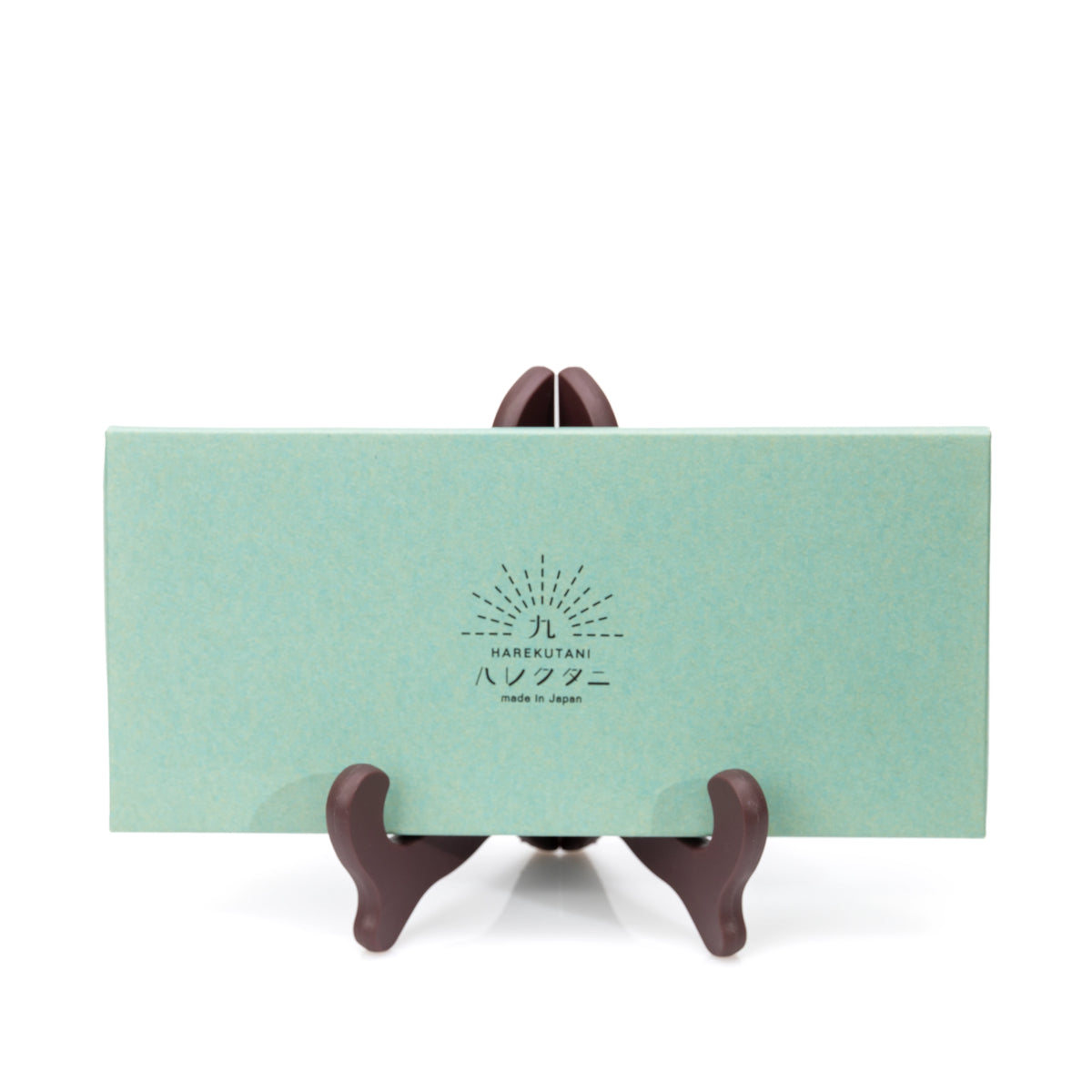 Closed green presentation box for the chopstick set.