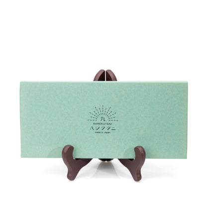 Closed green presentation box for the chopstick set.