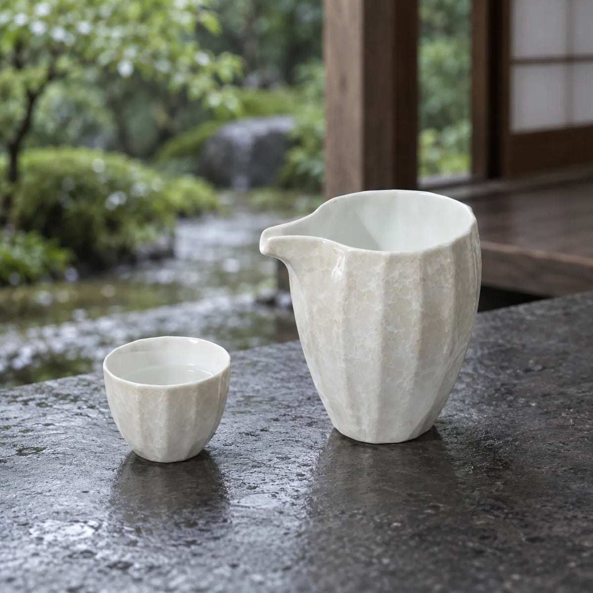 White Jinpoh Champagne luster katakuchi pourer and matching small sake cup on a shaded veranda
