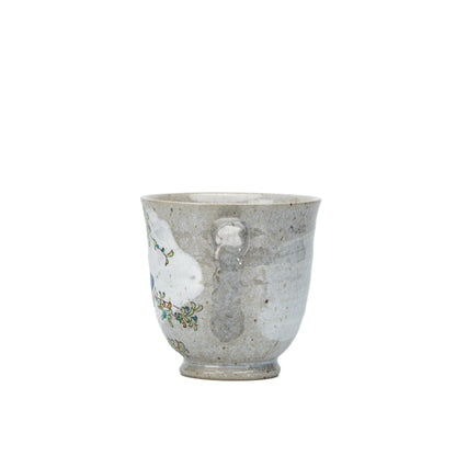 Side view of the Kutani kingfisher mug showing its mottled gray glaze.