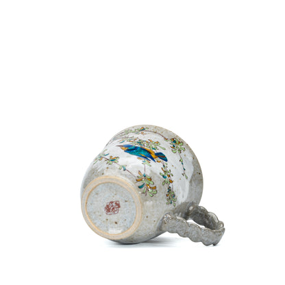 Underside of the Kutani kingfisher mug showing its foot and red maker's mark.