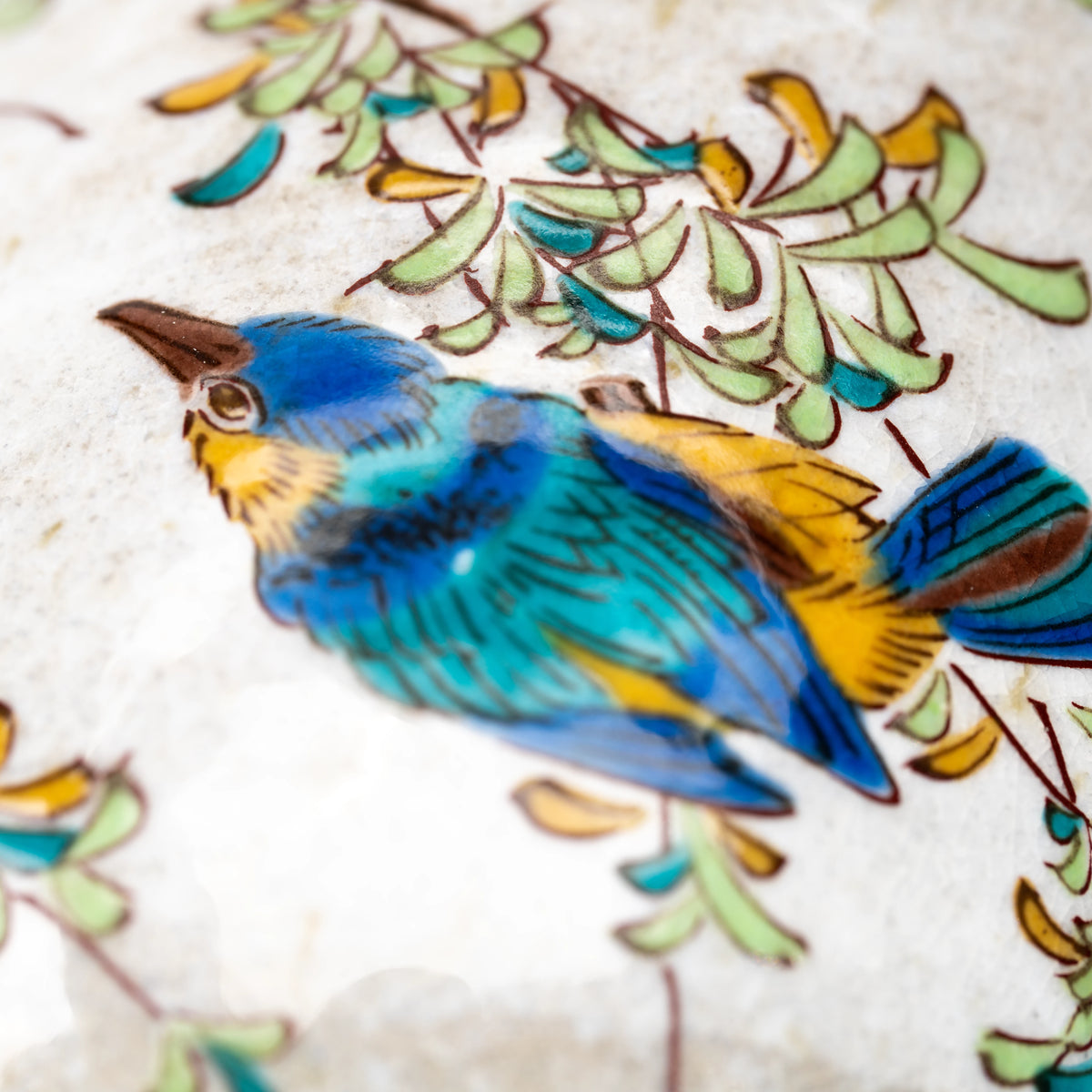 Close-up of a blue and yellow kingfisher on the Kutani mug.