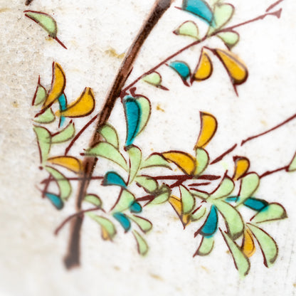 Close-up of leafy branches on the Kutani kingfisher mug.