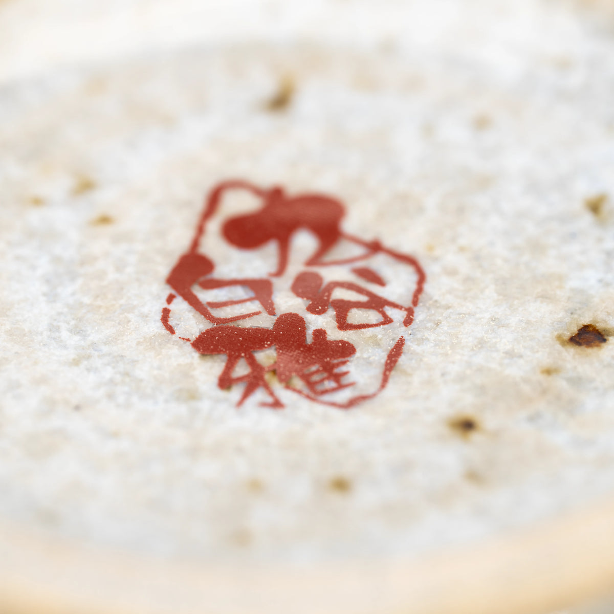 Close-up of the red maker's mark underneath the Kutani kingfisher mug.