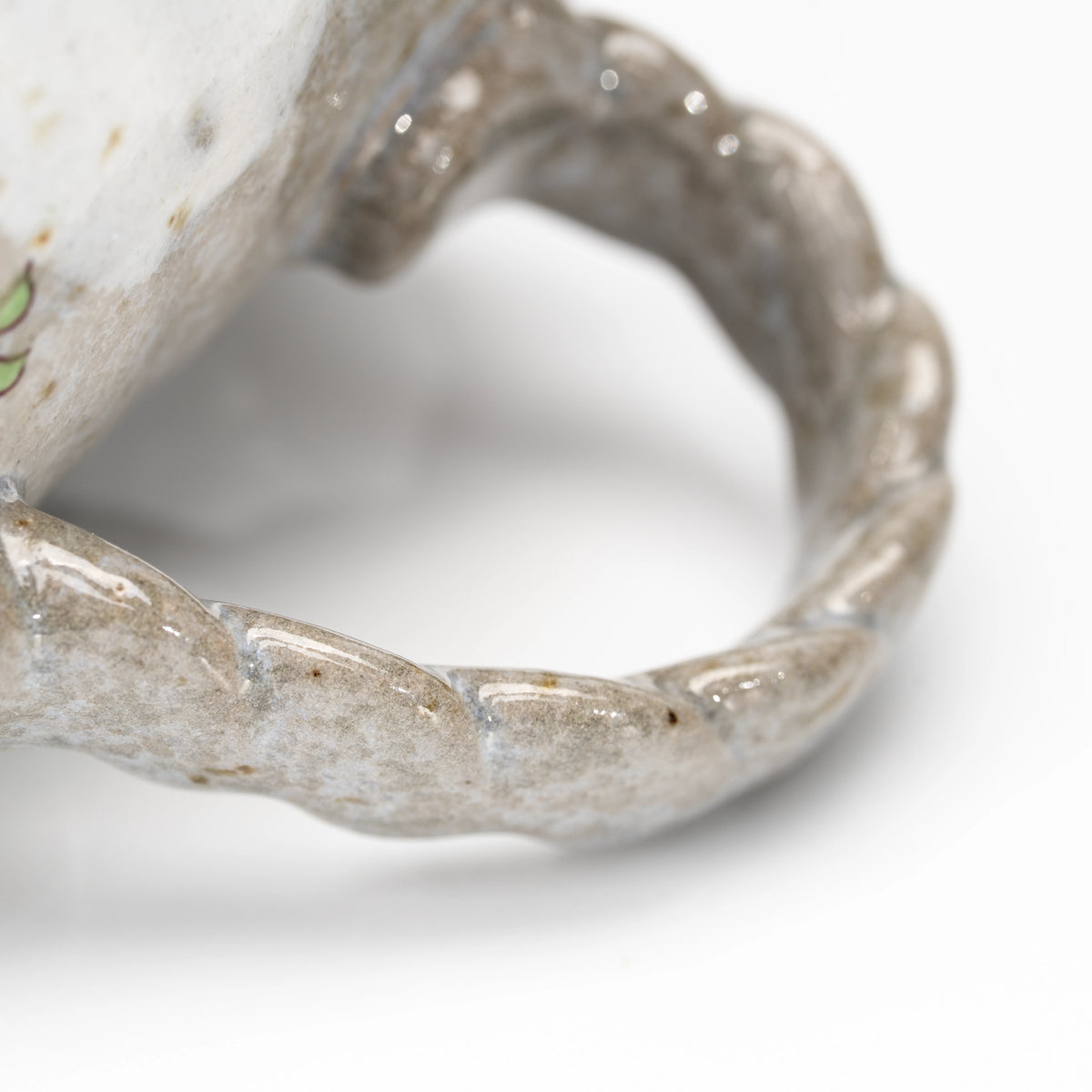 Close-up of the textured loop handle on the Kutani kingfisher mug.