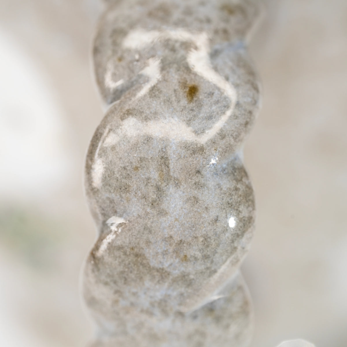 Close-up of pale spiral markings on the Kutani kingfisher mug's handle.