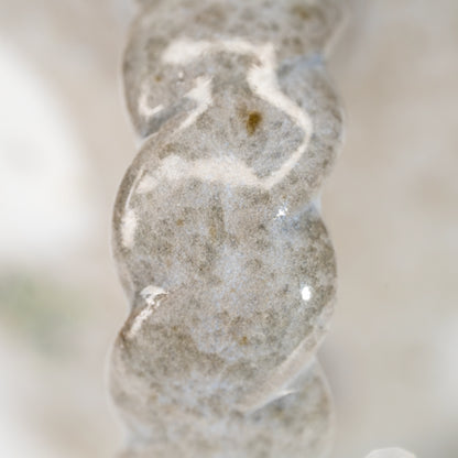 Close-up of pale spiral markings on the Kutani kingfisher mug's handle.