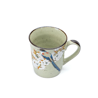 Angled view of the bird mug's pale green glazed interior.