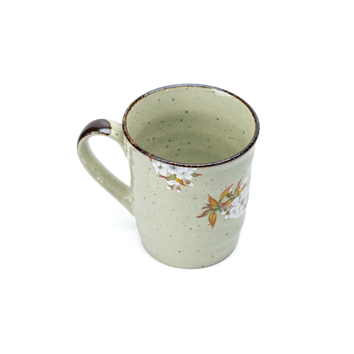 Opposite side of the pale green mug and its curved handle.