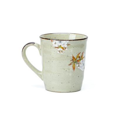 Side view of white cherry blossoms painted near the mug's rim.