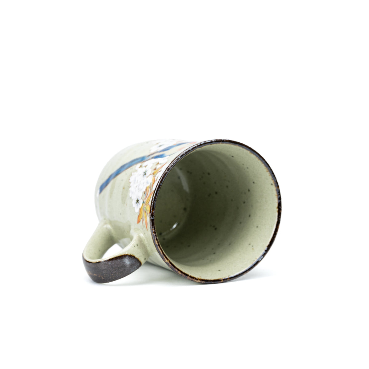 Overhead view into the pale green glazed bird mug.