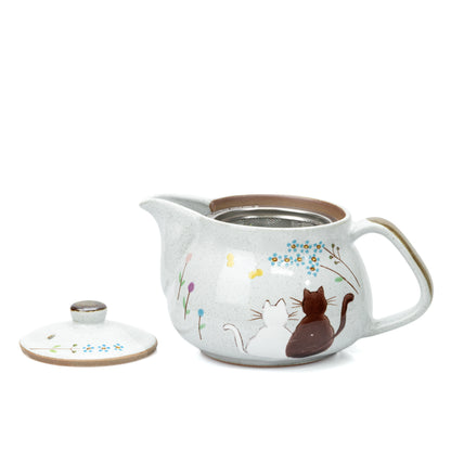 Open cat teapot with its removable metal tea strainer inside.