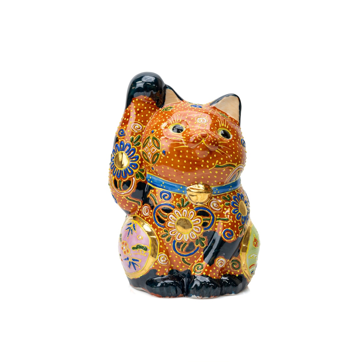 Orange and black Kutani lucky cat with one raised paw and dense gold floral decoration on white.