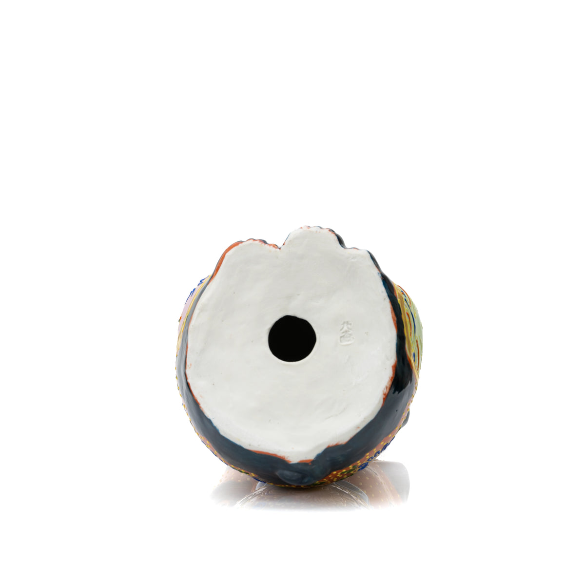 White underside of the lucky cat with a round opening.
